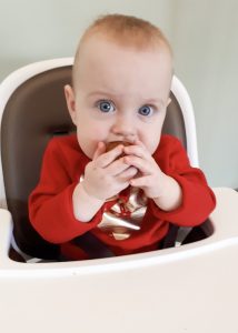 Baby eating muffin